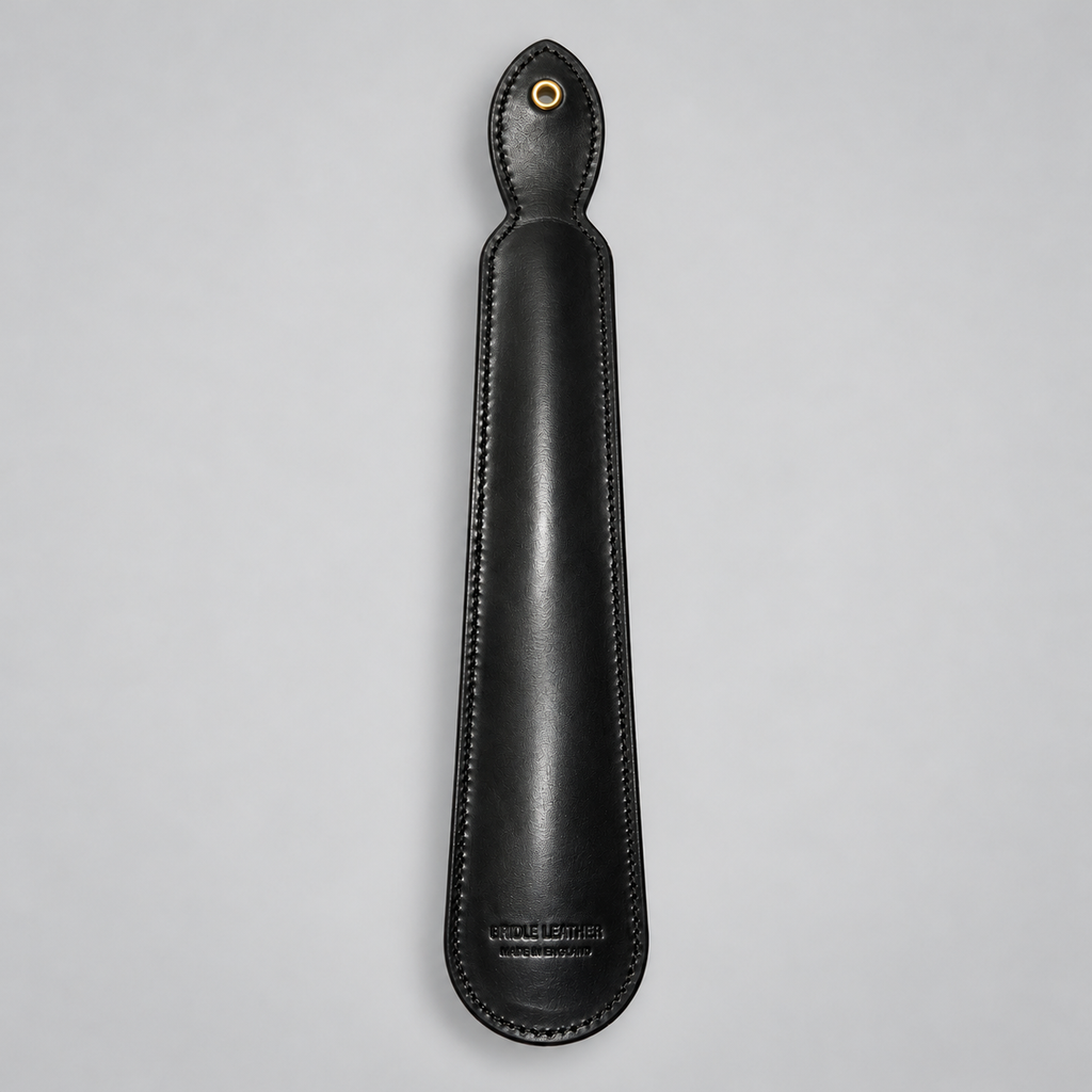 Reverse of black leather shoe horn showing hanging eyelet