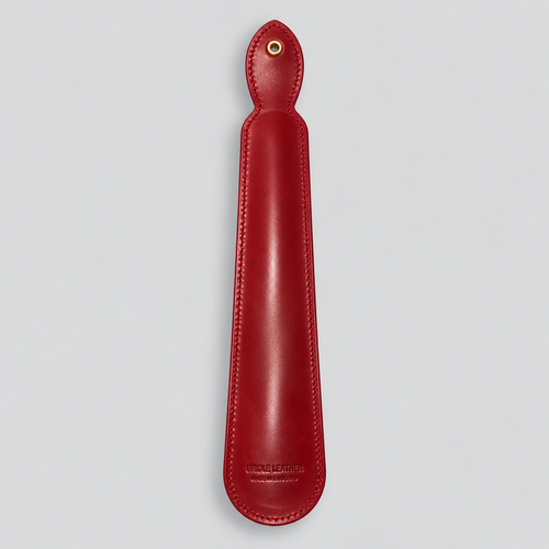 Reverse of red leather shoe horn with hanging eyelet