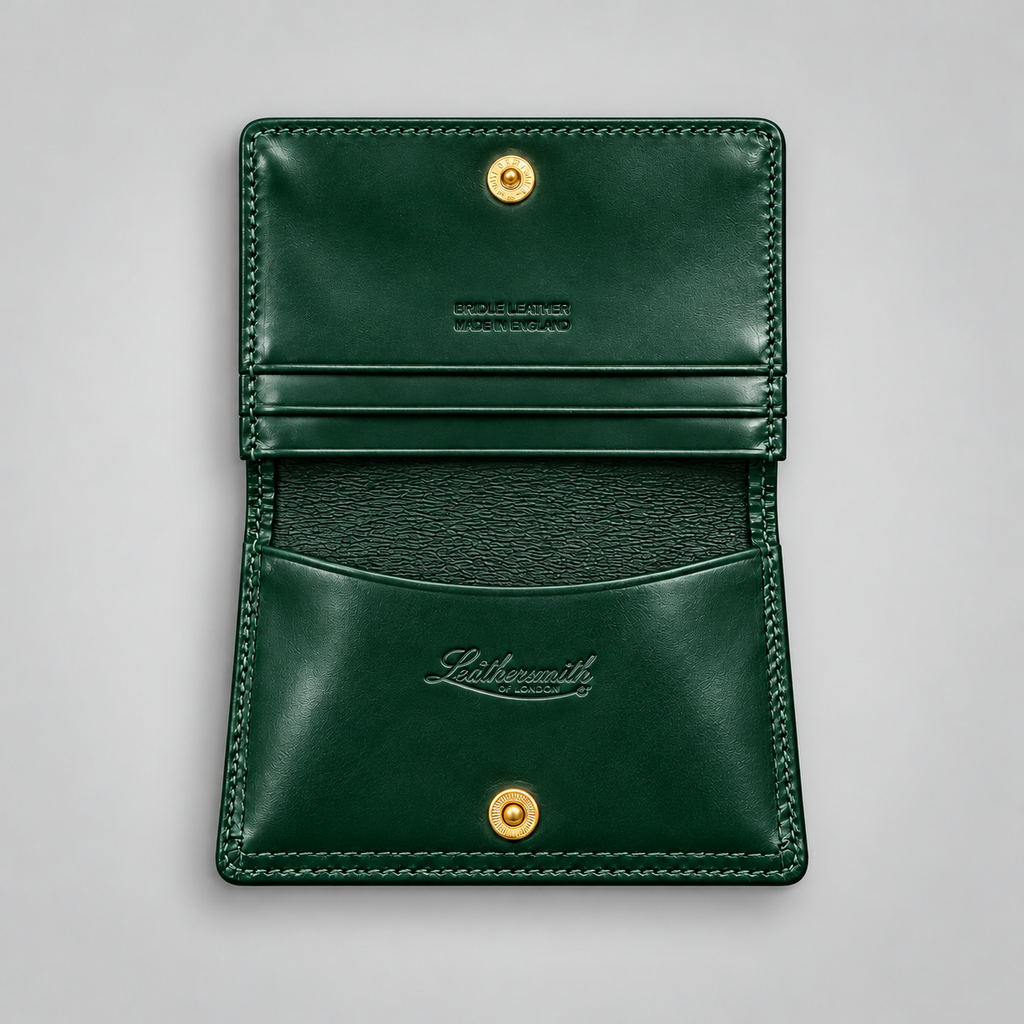 A dark green leather card holder wallet shown open against a light gray background, featuring gold-tone snap buttons and an embossed 'Leathermith' logo.