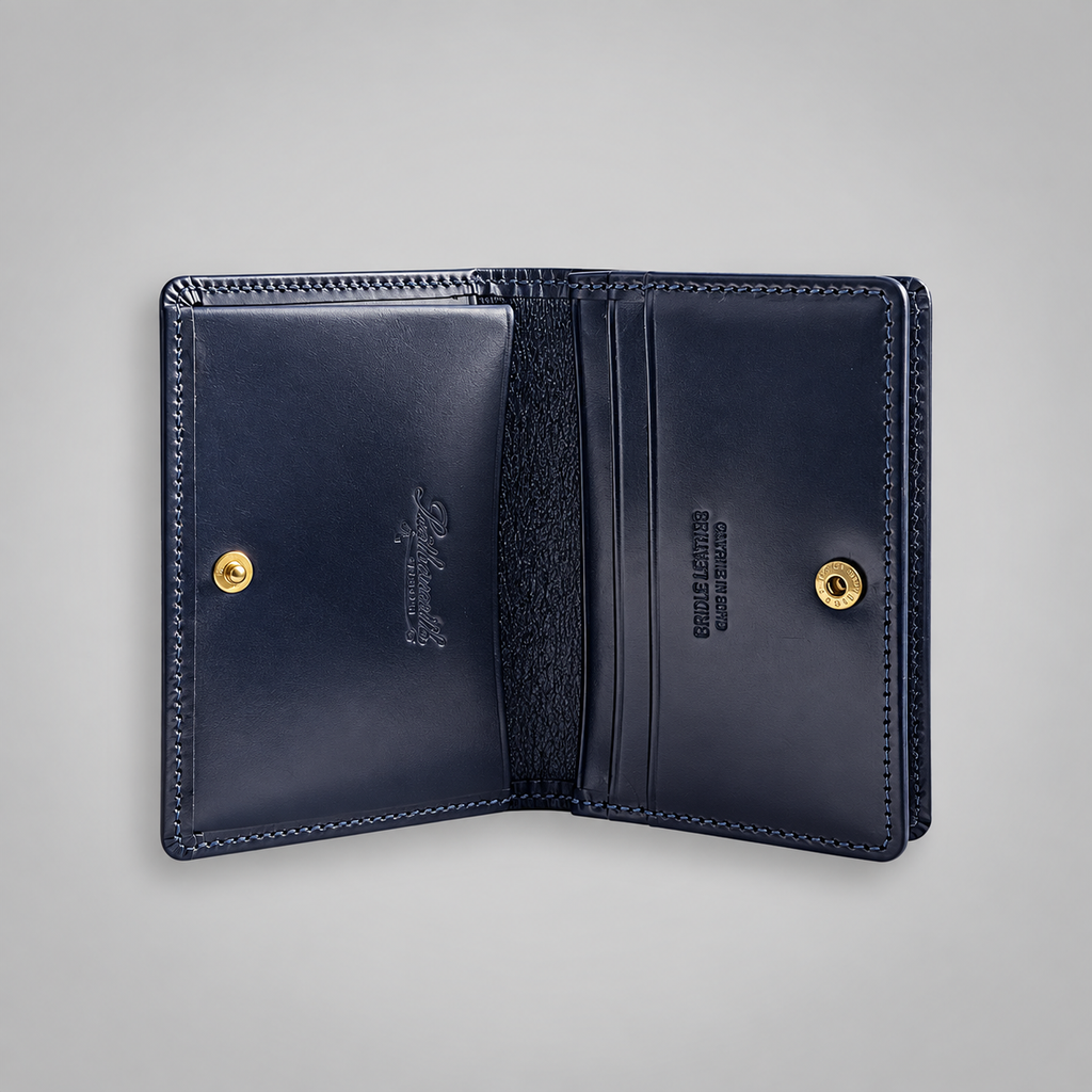 Open navy bridle leather business card case showing two compartments