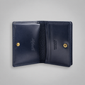 Open navy bridle leather business card case showing two compartments