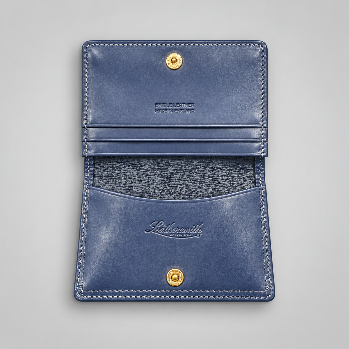 Navy leather business card case with gusseted pocket and press-stud closure