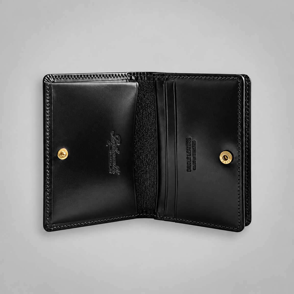 Open black bridle leather business card case with press-stud fastening