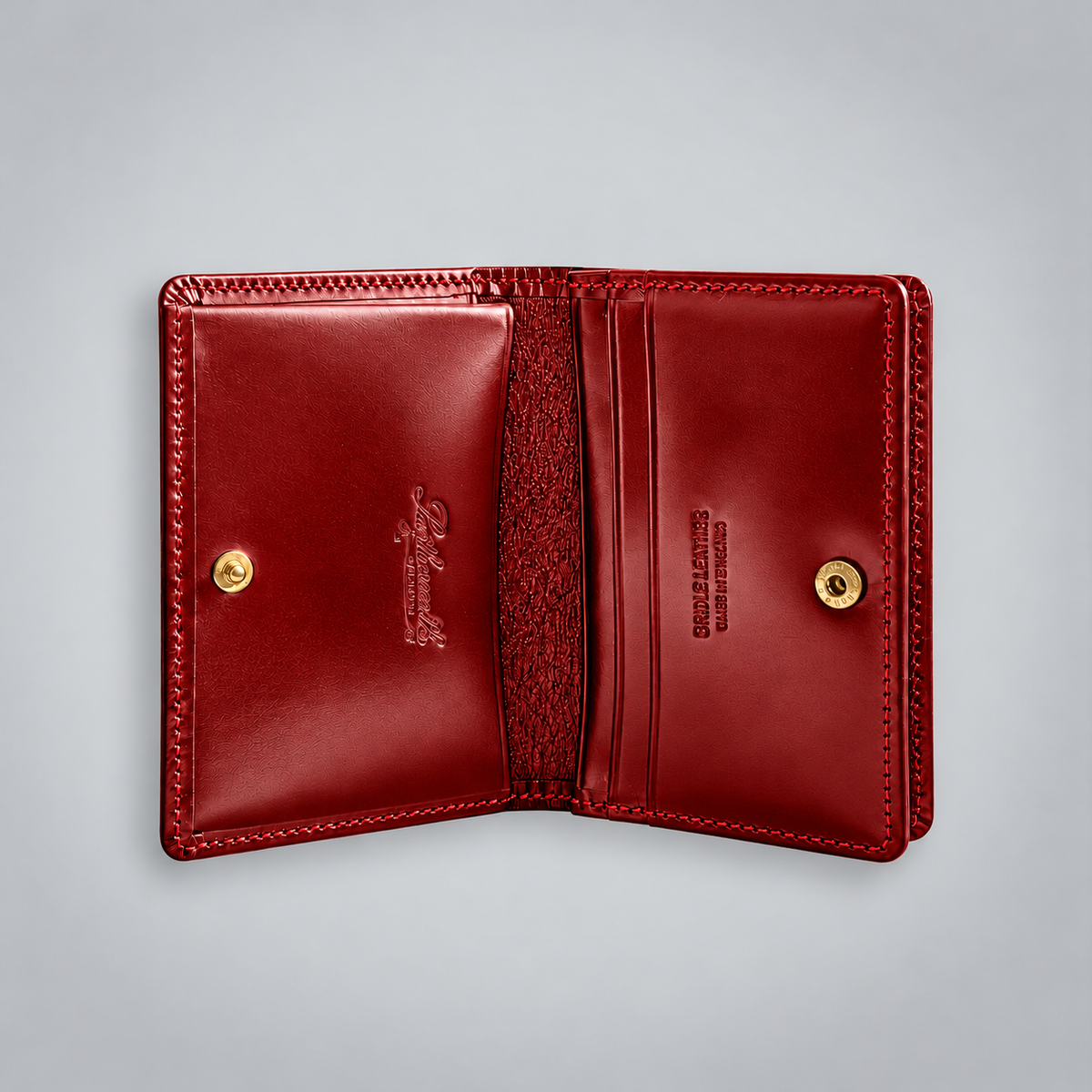 Open red bridle leather business card case showing two compartments